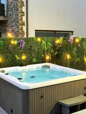 a jacuzzi tub in a garden with lights at 6 Bed in Winnards Perch oc-t29966 in Saint Columb Major