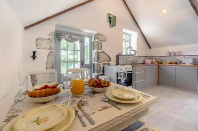 a kitchen with a table with food and wine glasses at 2 Bed in Trewoon oc-t29504 in St Austell