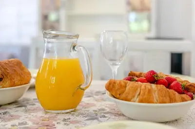 a table with a glass of orange juice and a bowl of fruit at 2 Bed in Trewoon oc-t29504 in St Austell