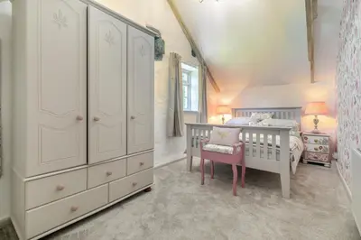 a bedroom with a bed and a dresser and a crib at 2 Bed in Trewoon oc-t29504 in St Austell