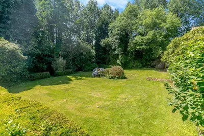 a large grassy yard with trees in the background at 1 Bed in Trewoon oc-t29505 in St Austell