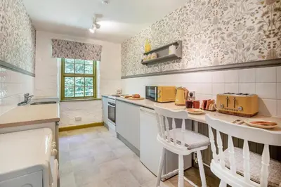 a kitchen with white counter tops and yellow appliances at 1 Bed in Trewoon oc-t29505 in St Austell