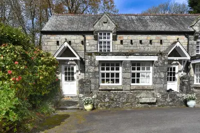 an old stone house with white doors and windows at 1 Bed in Trewoon oc-t29505 in St Austell