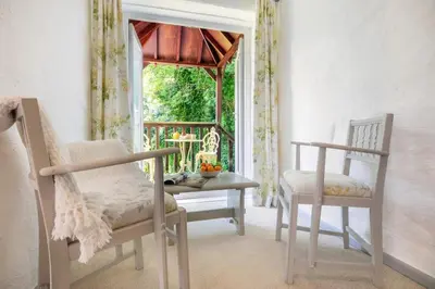 a room with two chairs and a table and a window at 1 Bed in Trewoon oc-t29505 in St Austell