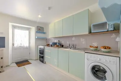 a kitchen with a washer and a washing machine at 2 Bed in Trewoon oc-t29503 in St Austell