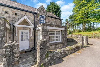 an old stone cottage with a white door at 2 Bed in Trewoon oc-t29503 in St Austell