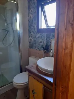 a bathroom with a toilet and a sink and a shower at Puddle Duck Peeps Out Chalet in Saint Martin