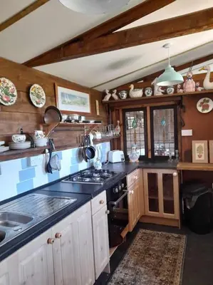 a kitchen with a sink and a stove top oven at Puddle Duck Peeps Out Chalet in Saint Martin