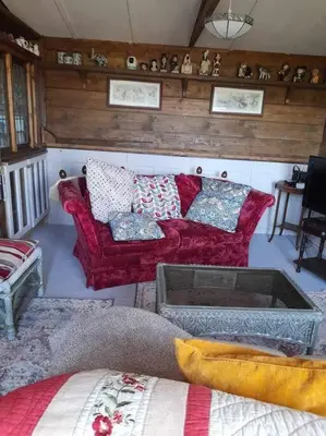 a living room with two red couches and a table at Puddle Duck Peeps Out Chalet in Saint Martin