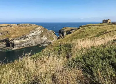 a view of the ocean from the cliffs at 17th Century Traditional Tintagel Farmhouse with Hot Tub in Treknow