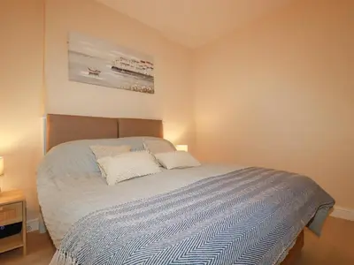 a bedroom with a bed with two pillows on it at Serendib Cottage in Newquay