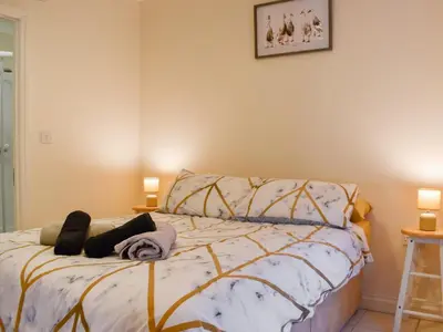 a bedroom with a bed and two lamps at Lavrean Farm in St Austell