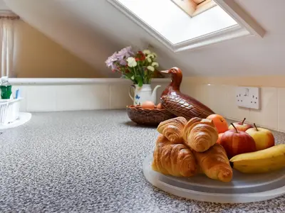 a plate of fruit and croissants on a counter at Lavrean Farm in St Austell
