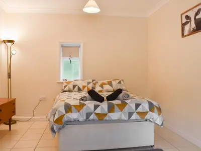 a bedroom with a bed and a window at Lavrean Farm in St Austell
