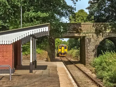 a yellow train is coming through a tunnel at The Shepherds Hut At Rosewood House in Liskeard
