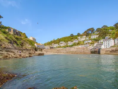 a body of water with a beach and buildings at Charlie Wilcox Cottage in Polperro