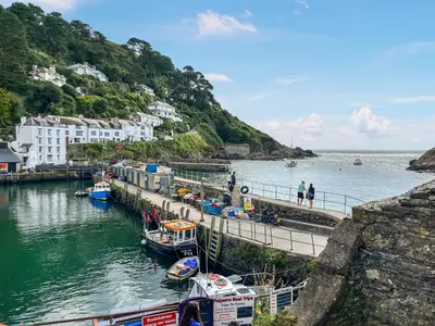 a group of boats are docked in a harbor at Charlie Wilcox Cottage in Polperro