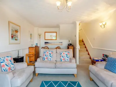 a living room with two couches and a bed at River View in Wadebridge