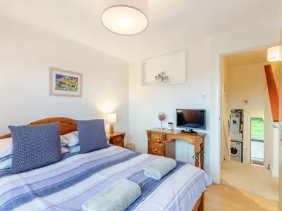 a bedroom with a bed and a television at River View in Wadebridge