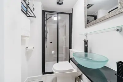 a bathroom with a glass sink and a toilet at Fowey, quaint cottage near sea in Fowey