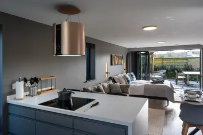 a kitchen and living room with a couch and a bed at Uno Carbis Bay - Boutique Luxury Accommodation in Carbis Bay
