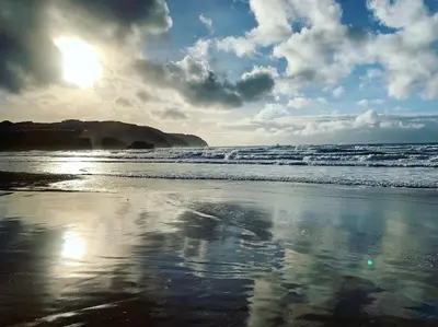 a beach with the ocean and the sky and clouds at Countryside Cabin in Private Setting in Redruth