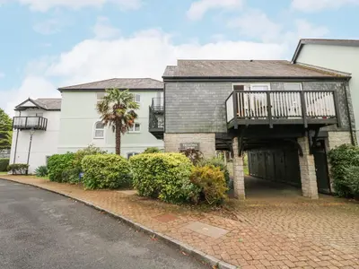 a large white house with a balcony and a driveway at 5 Tregenna Court in Falmouth