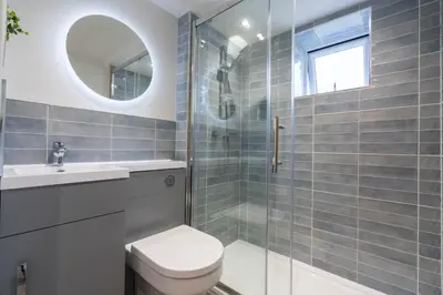 a bathroom with a toilet and a glass shower at Griffin's Rest - Parking, Countryside views in Newquay