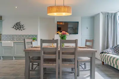 a kitchen and dining room with a table and chairs at Griffin's Rest - Parking, Countryside views in Newquay