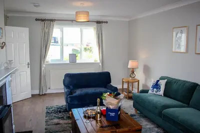 a living room with a couch and a table at Chestnut House in Saint Columb Minor