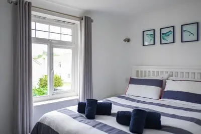 a bedroom with two beds and a window at Eventide in Newquay