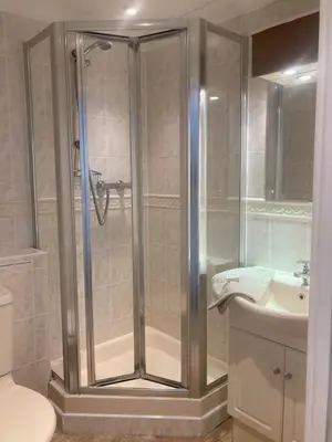 a bathroom with a shower and a toilet and a sink at Eventide in Newquay