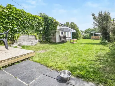 a yard with a patio and a house at The Light House in Gwithian