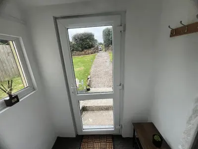 an open door in a room with a window at 1 Carnebone Cottages in Porkellis