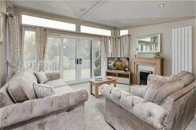 a living room with two couches and a fireplace at Pool - Fireplace - 2Br Lodge - PetsOK - Parking in Newquay