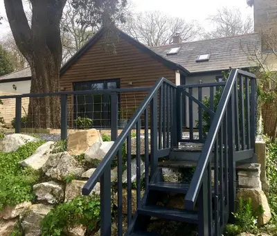 a staircase leading to a house with a tree at Stunning getaway in Wadebridge, Cornwall in Wadebridge
