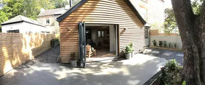 a small house with a door open on a patio at Stunning getaway in Wadebridge, Cornwall in Wadebridge