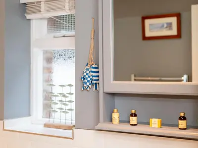 a kitchen with a mirror and some bottles on a shelf at Holiday Home Elm Cottage by Interhome in Mevagissey