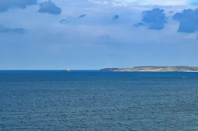 a large body of water with two islands in the distance at Finest Retreats - Blue Horizon in St Ives