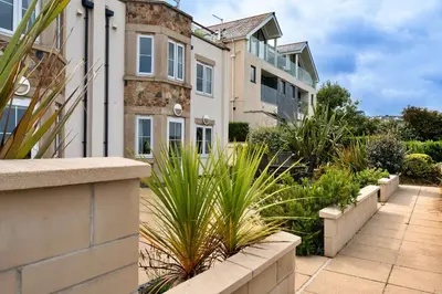 an apartment building with plants in front of it at Finest Retreats - Blue Horizon in St Ives
