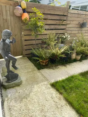 a statue of a little boy standing in a garden at Seashells in Padstow