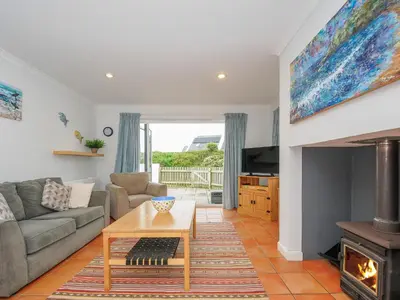 a living room with a couch and a fireplace at Bryher in Wadebridge