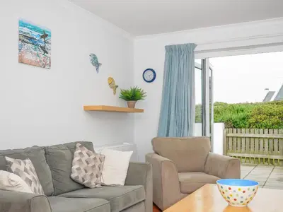 a living room with a couch and two chairs and a table at Bryher in Wadebridge