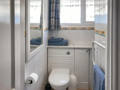 a small bathroom with a toilet and a window at K2 Cosy Lodge in Padstow