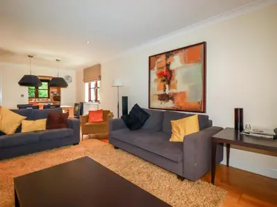 a living room with two couches and a table at Clematis - Lodge 16 in Wadebridge