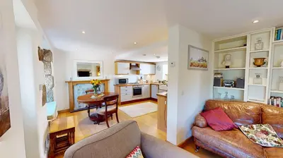 a living room with a couch and a table at 1 St Ives Higher Ayr Cottage in St Ives