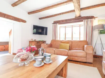 a living room with a couch and a table at Skiber Coombe in Callington