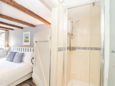 a guest bedroom with a shower and a bed at Skiber Coombe in Callington