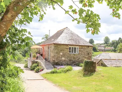 an old stone house with a stone path leading to it at Skiber Coombe in Callington