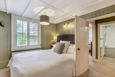 a bedroom with a large white bed and windows at 2 Bed in St. Columb oc-h29936 in Saint Columb Major